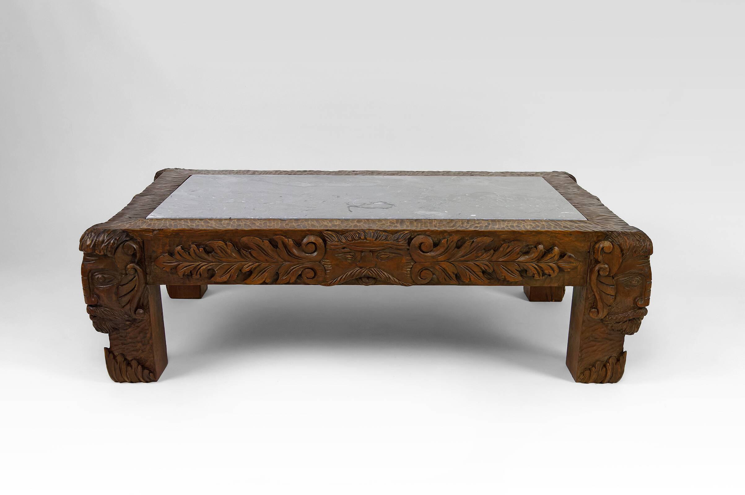 Solid oak coffee table carved with fauns and gray marble top, France, circa 1940