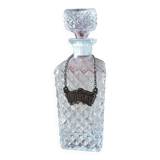 Chiseled glass whiskey decanter and its necklace marked “whiskey”