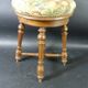 Old upholstered piano stool