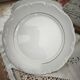 12 flat plates in porcelain with double gold rim.
