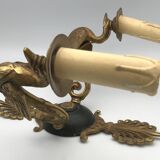 Antique bronze wall light with arm decorated with swans and palmettes in the Empire style