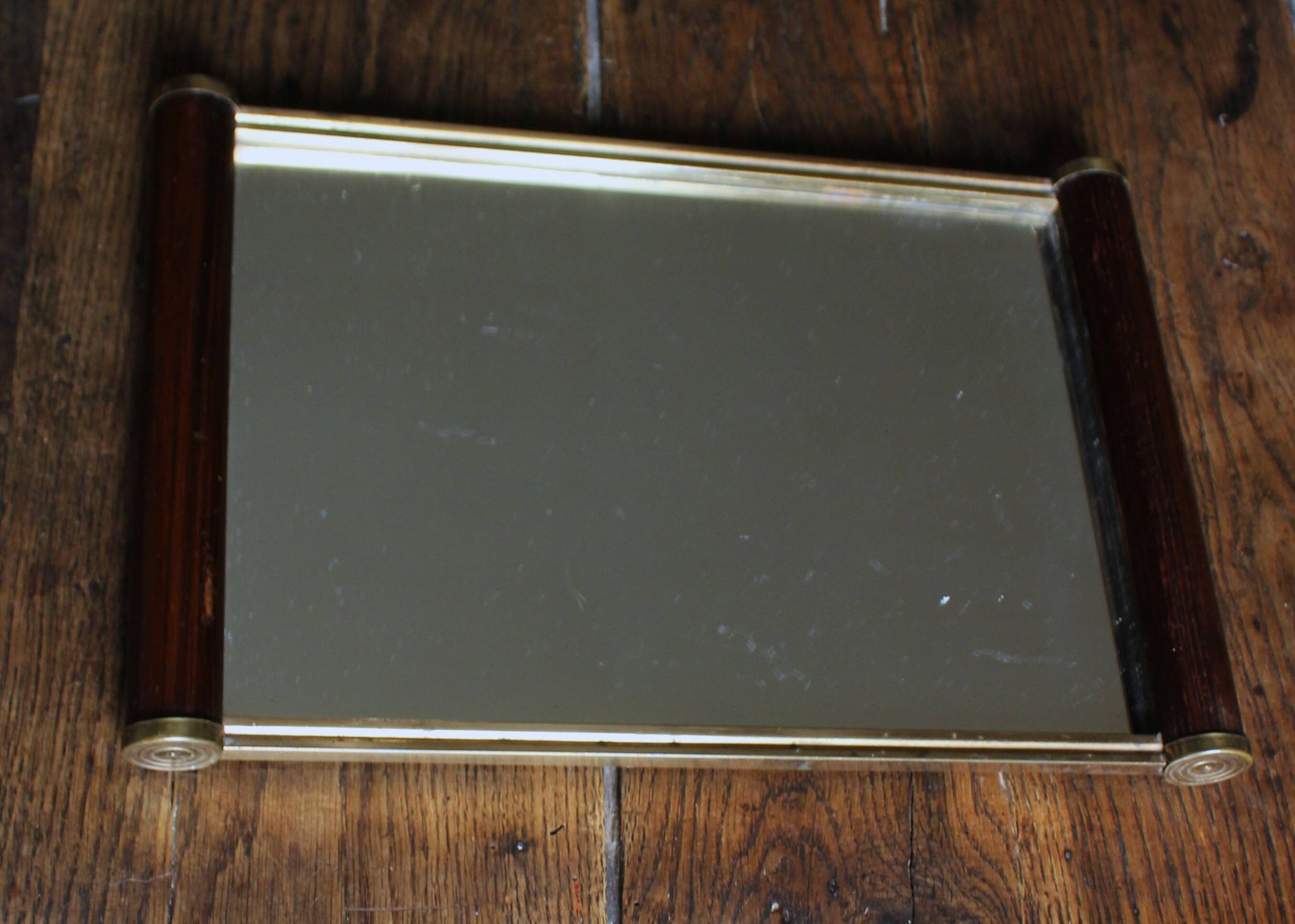 Rectangular mirror tray with wooden handles and gilding.