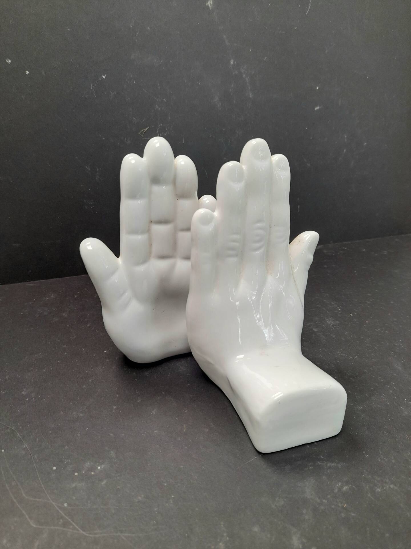 Ceramic bookends in the shape of hands.