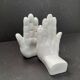 Ceramic bookends in the shape of hands.