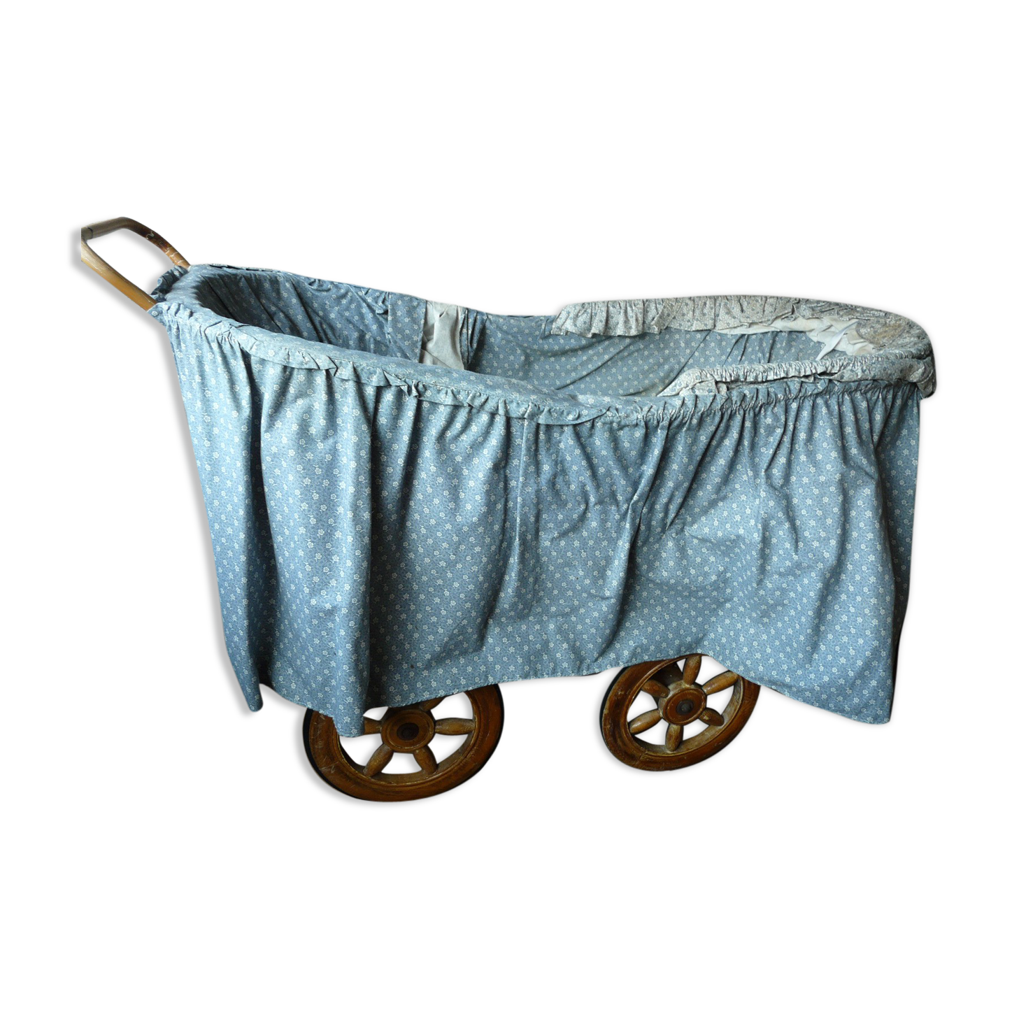 Old wooden cradle and wicker on wheels