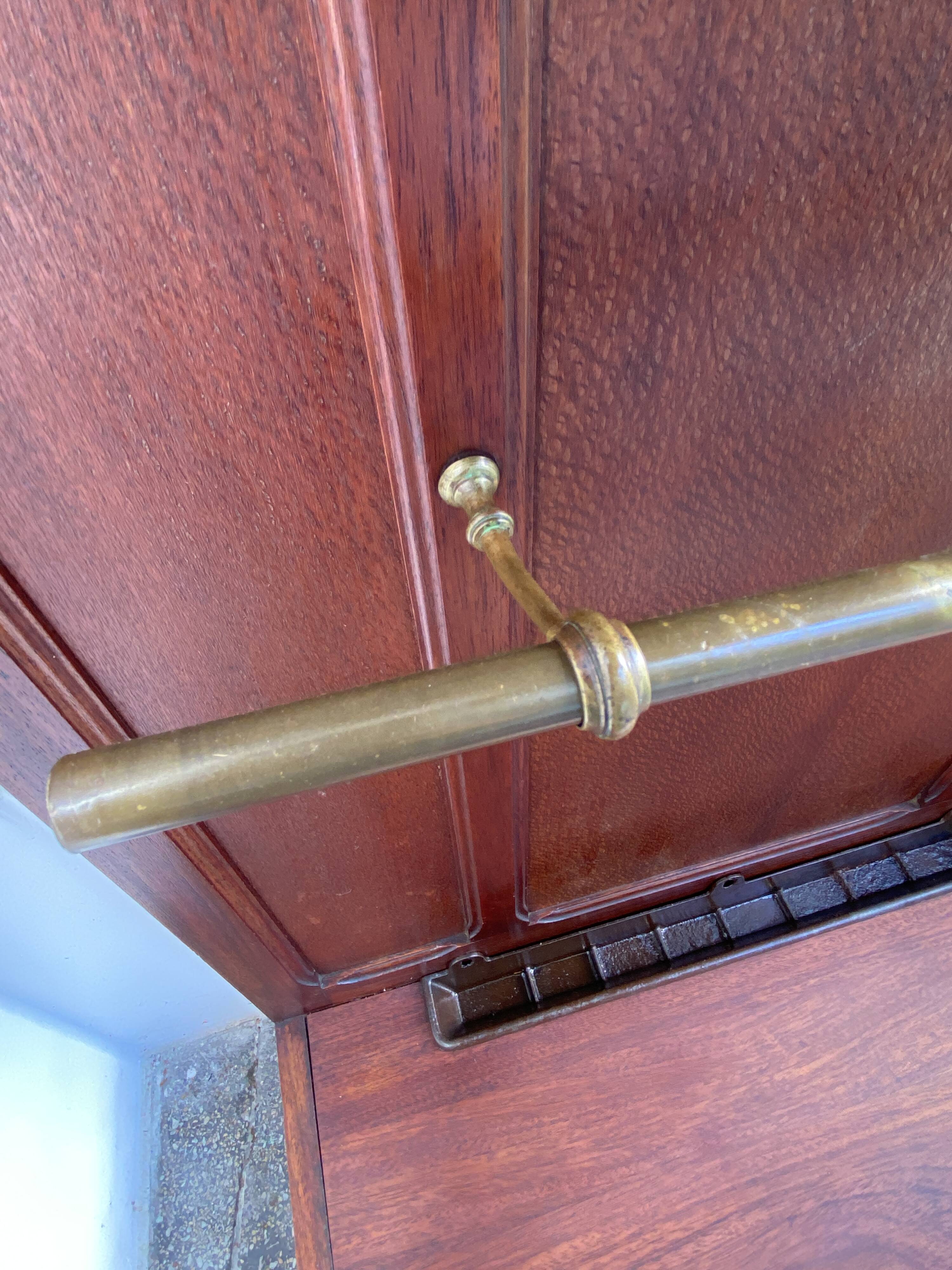 Antique wooden coat rack with mirror and shelf.