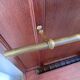 Antique wooden coat rack with mirror and shelf.