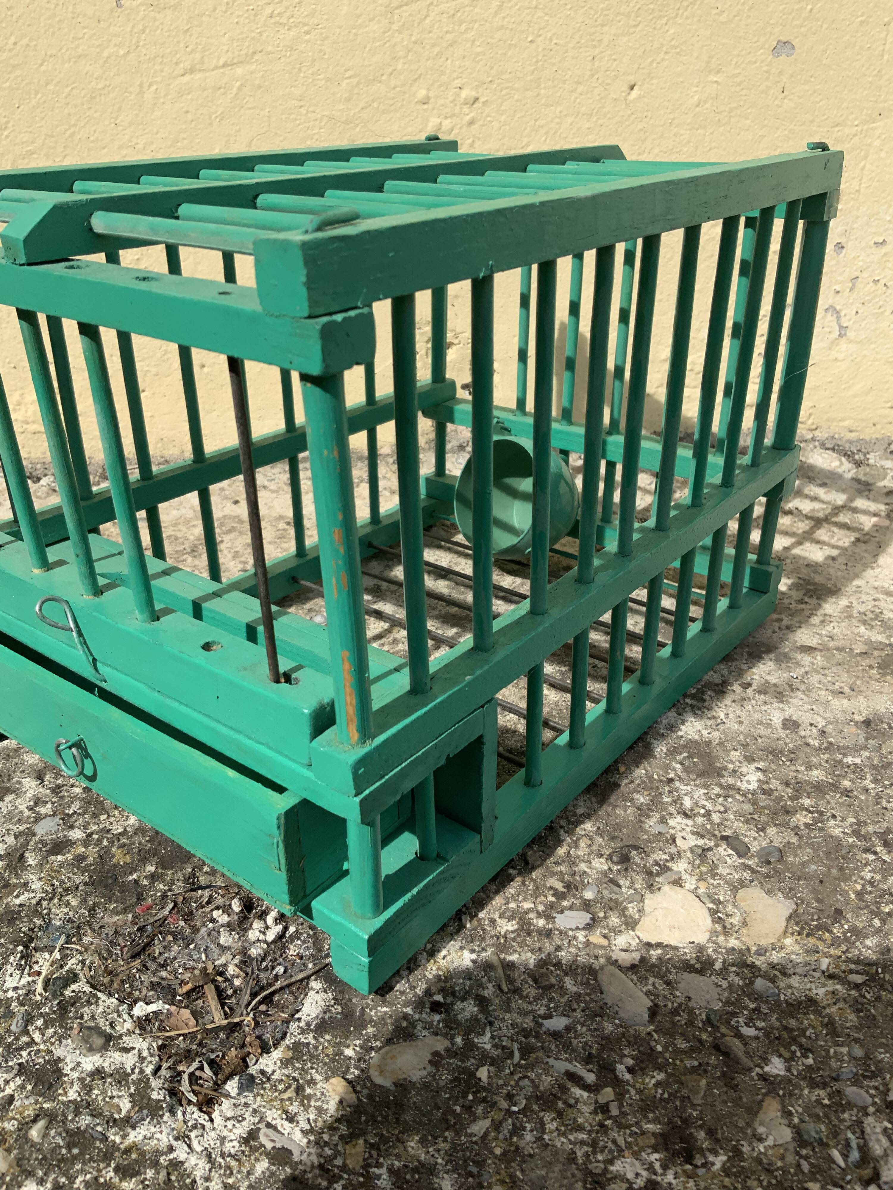 Vintage bird cage in green wood retro paint