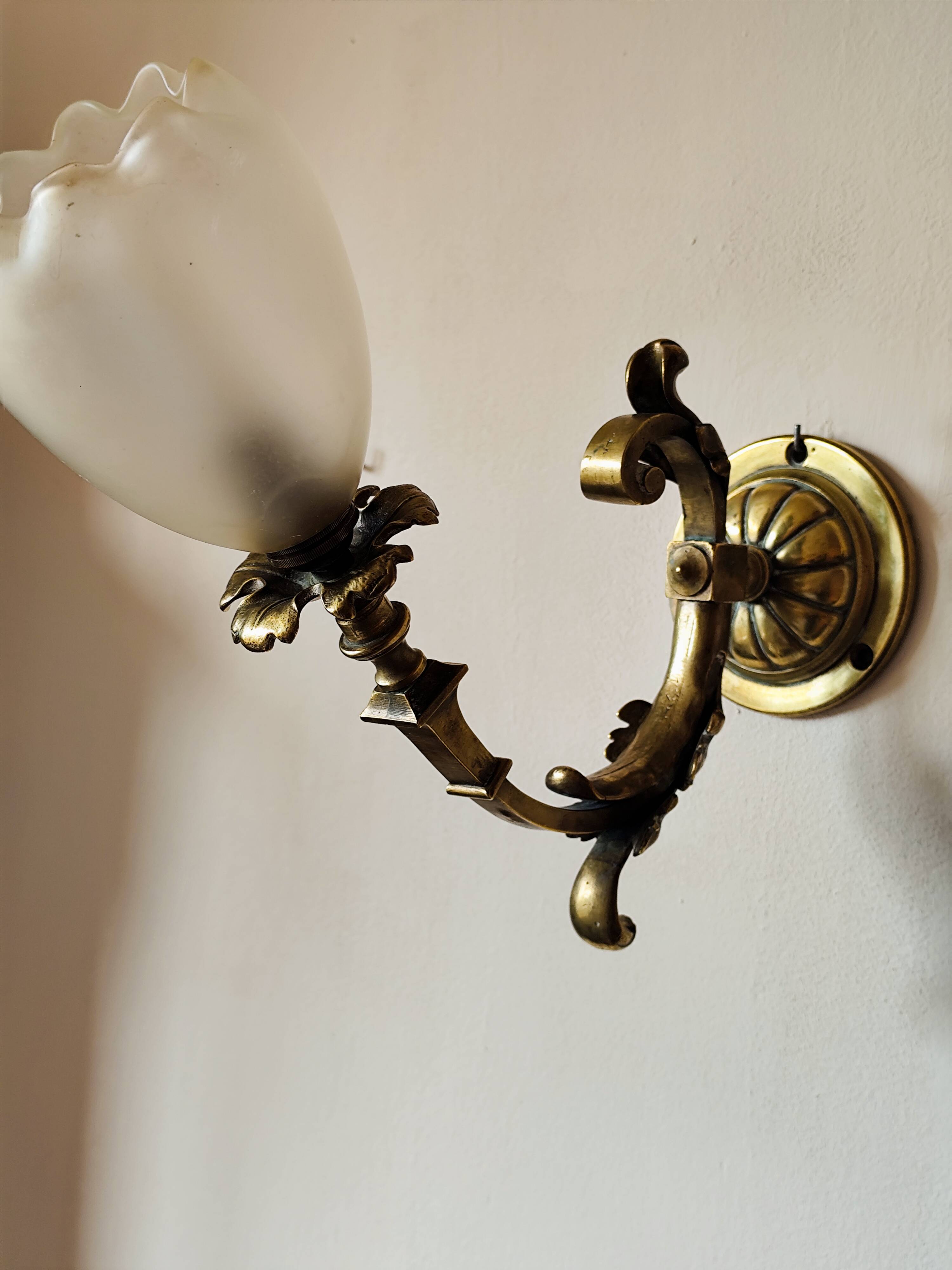 Bronze wall light with opaque glass tulip