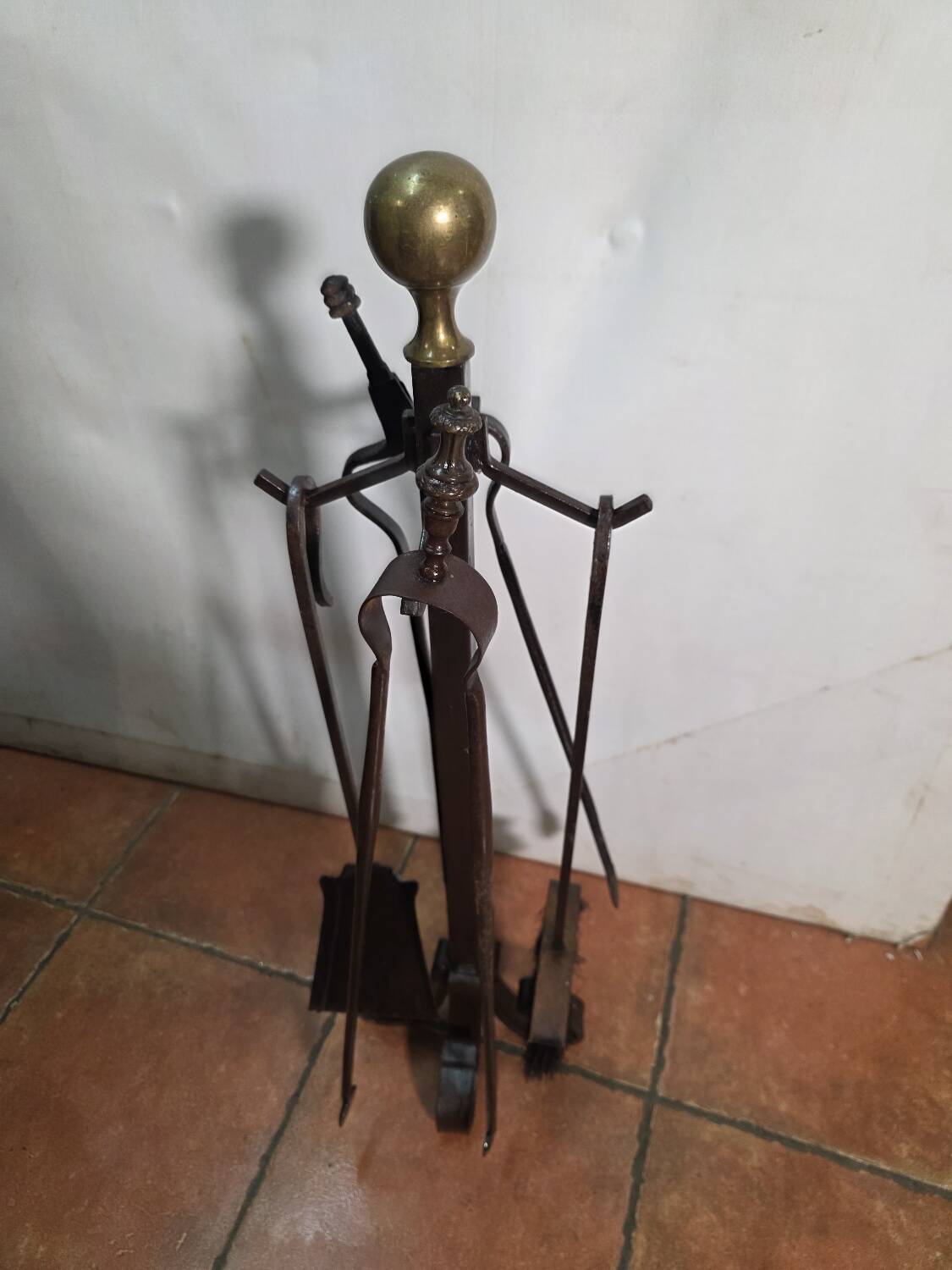 Antique fireplace set in solid wrought iron and brass.