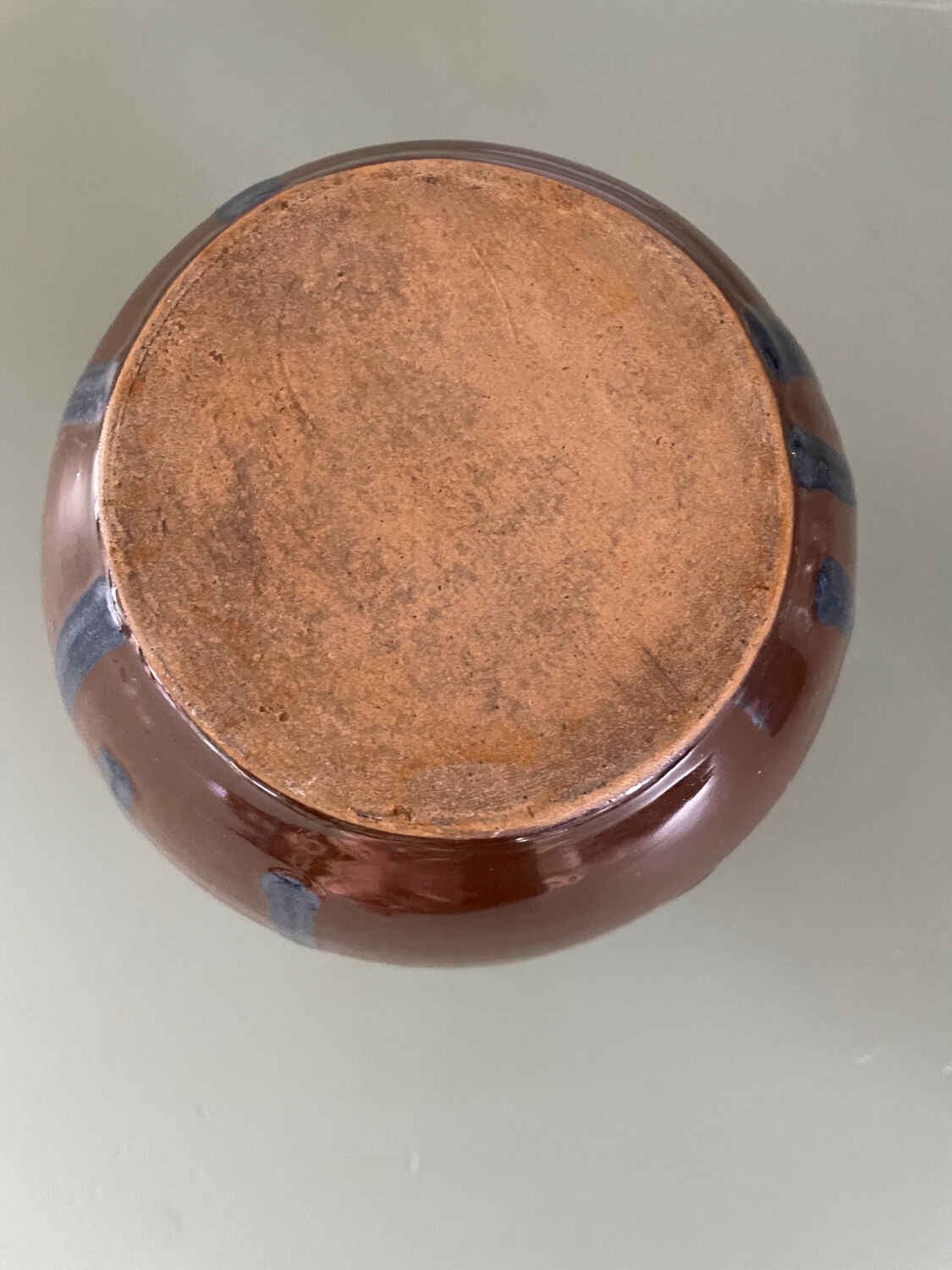 Old blue and brown vase with drips.