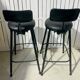 Pair of black bar stools in industrial and contemporary style.