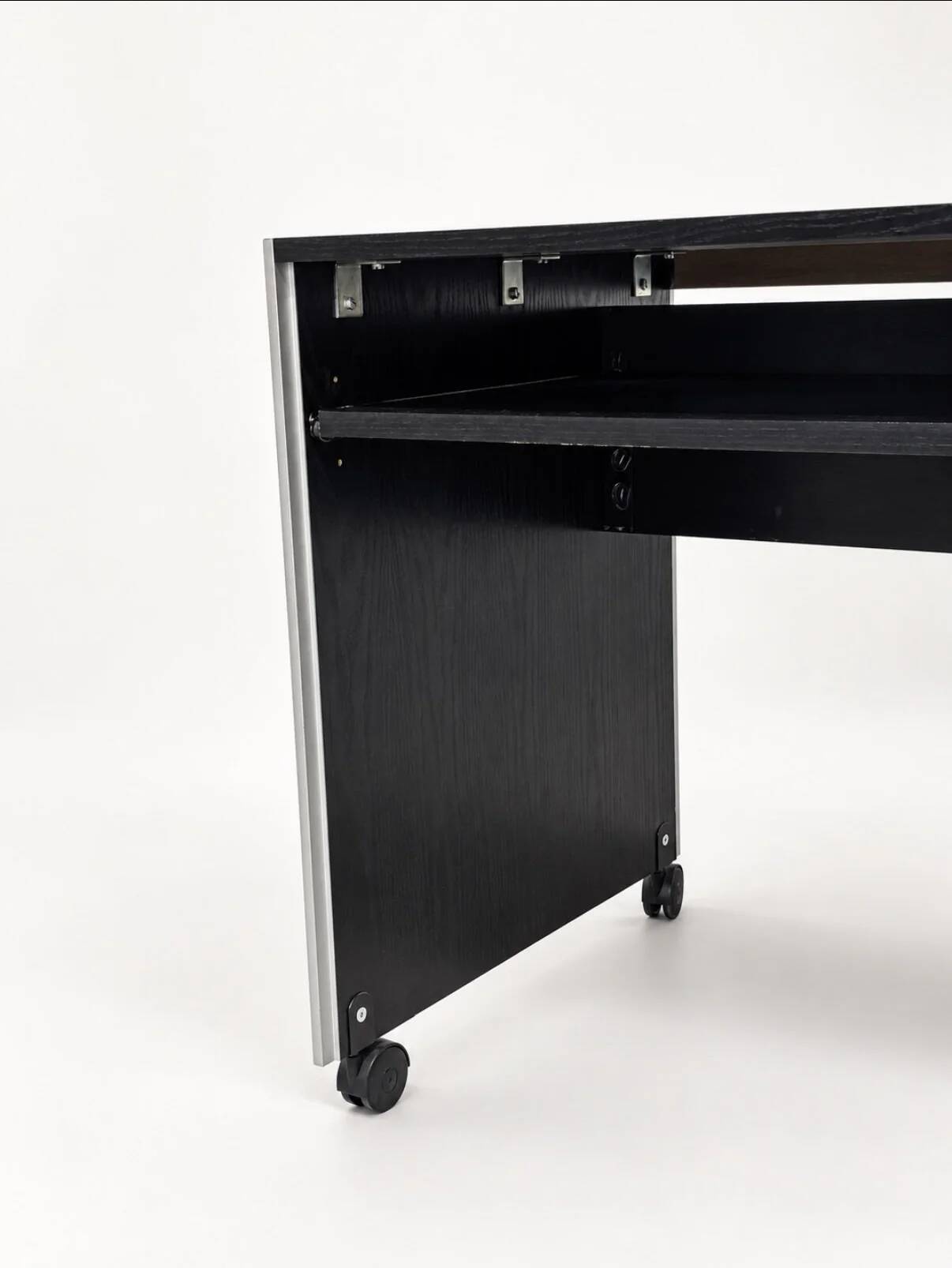 Vintage black computer desk on wheels with an aluminium edge.