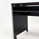 Vintage black computer desk on wheels with an aluminium edge.
