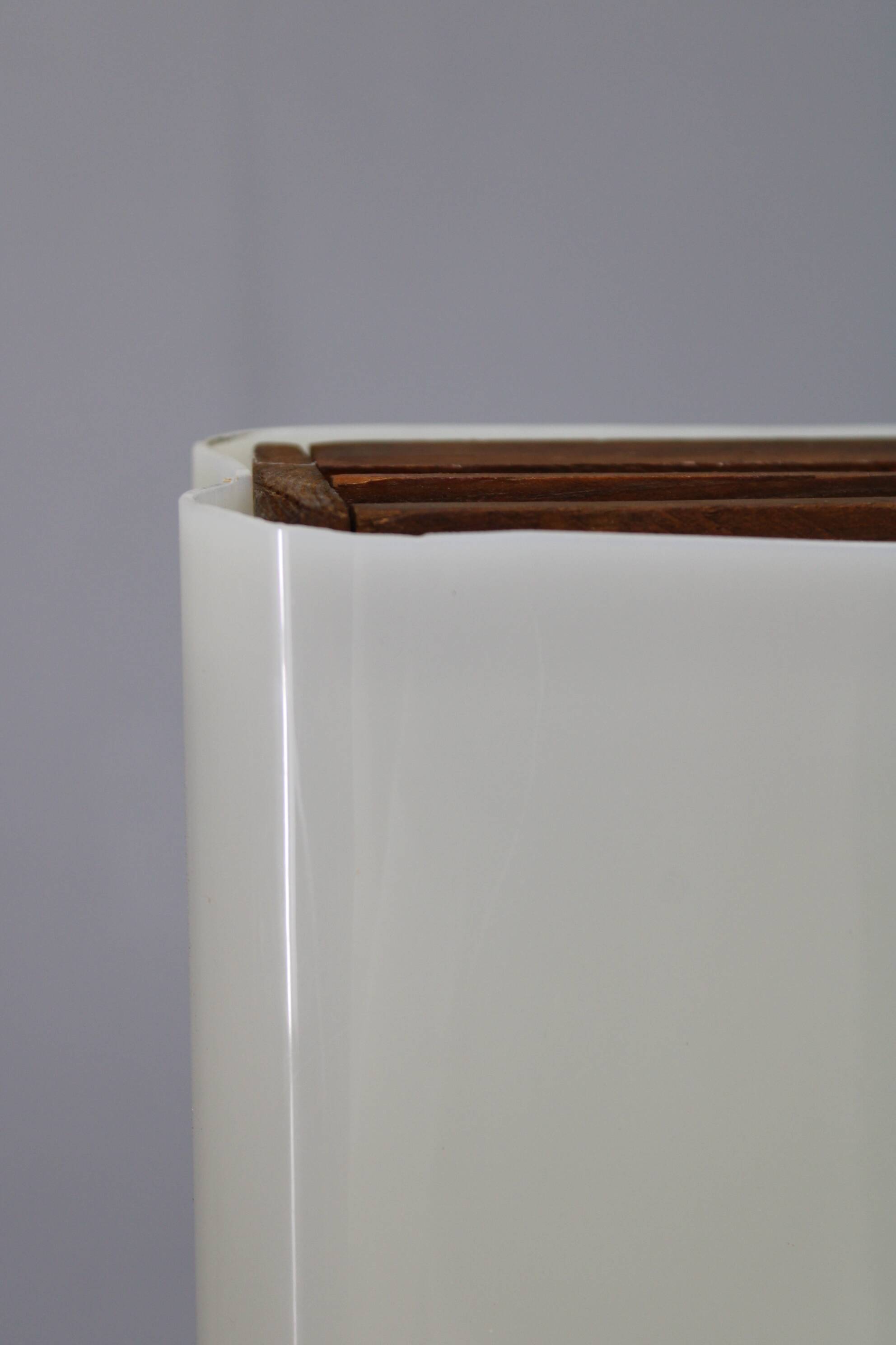 Mid-century modern floor lamp on iron legs with plastic shade and wood accent