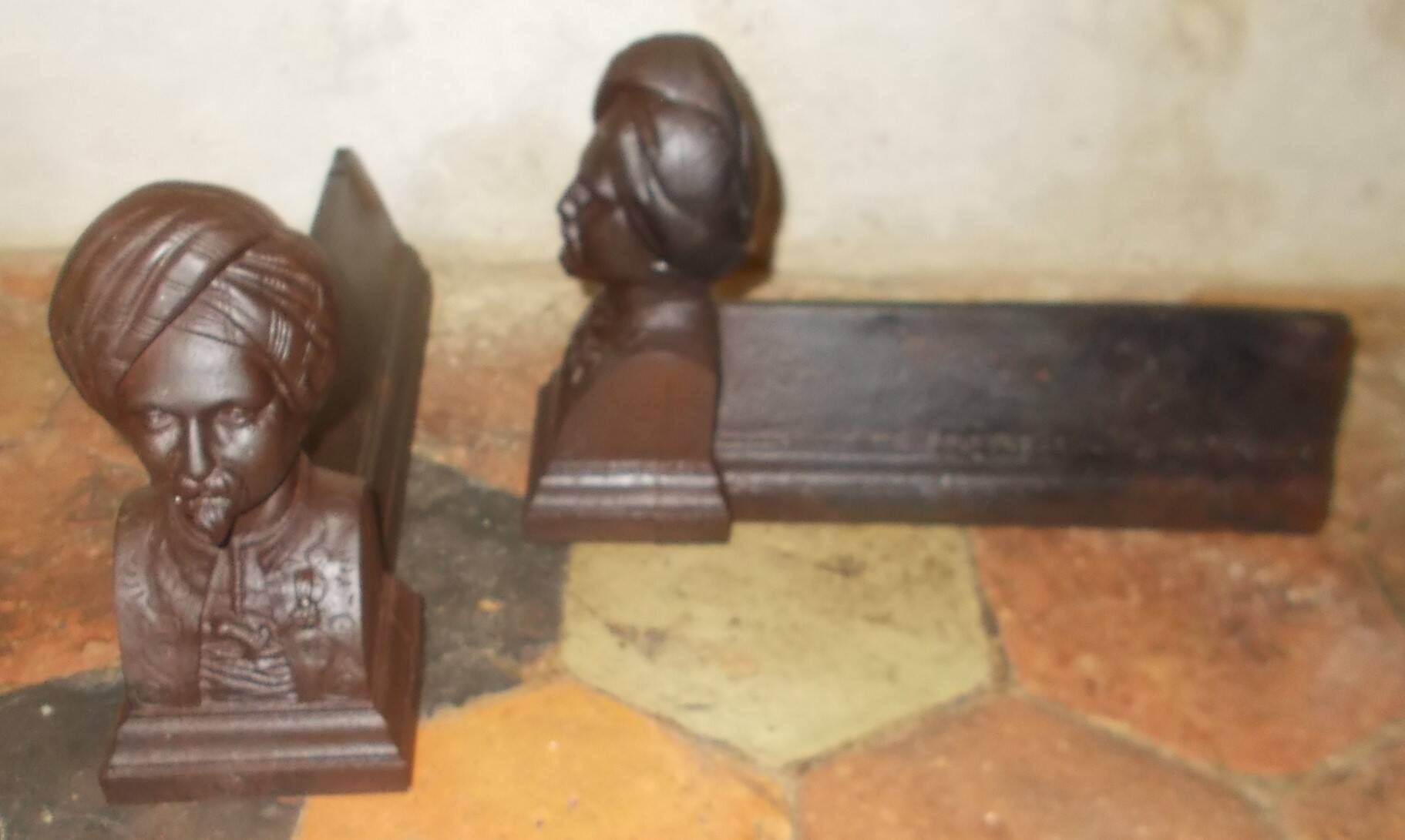 Old cast iron andirons with oriental decor