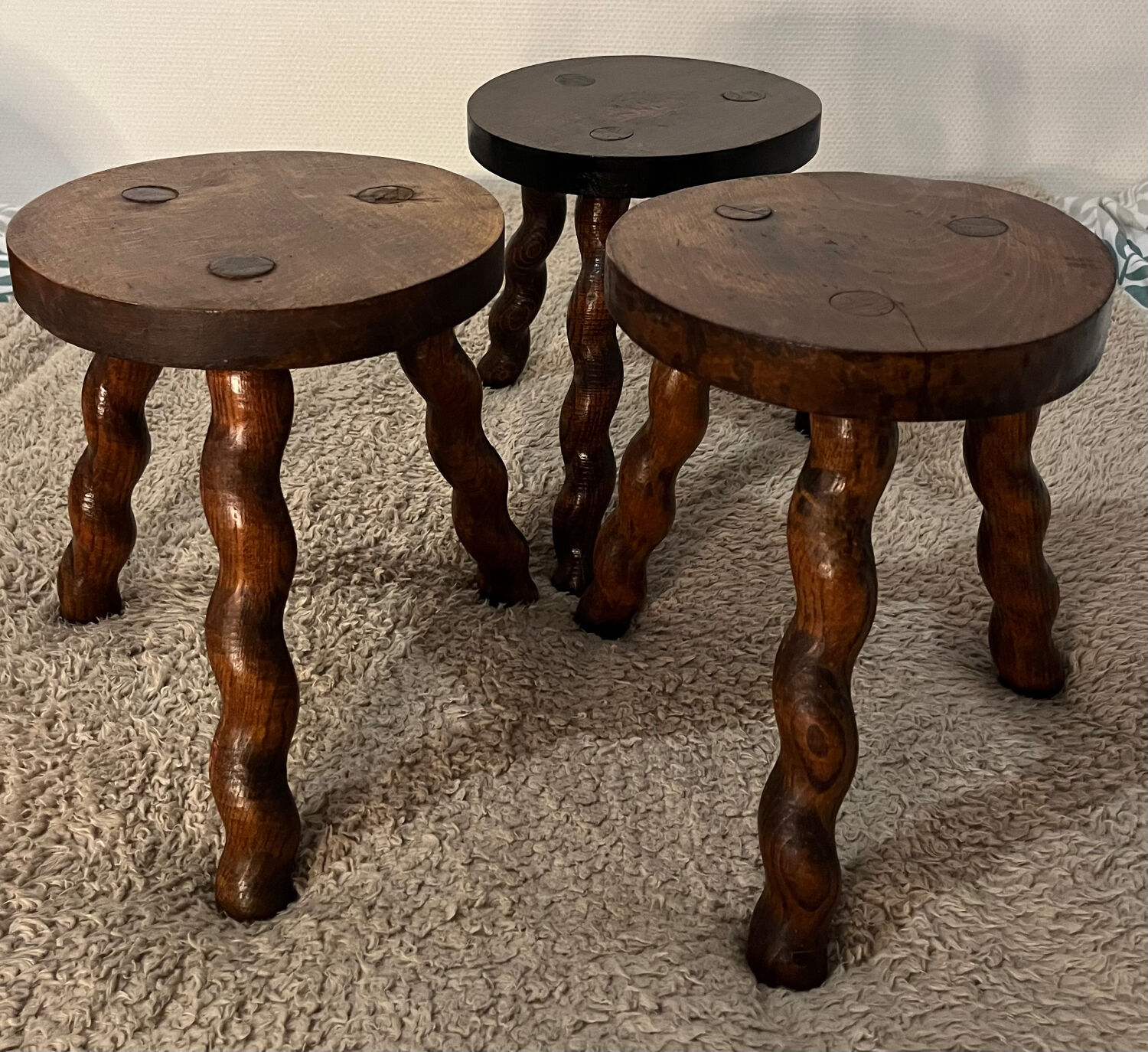 Wooden tripod stool with twisted legs