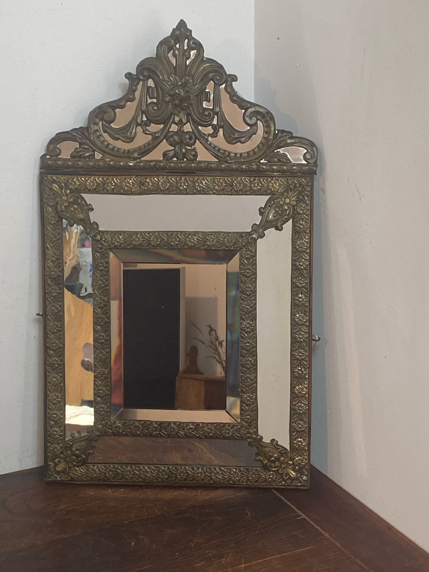 Mirror with brass repoussé frame