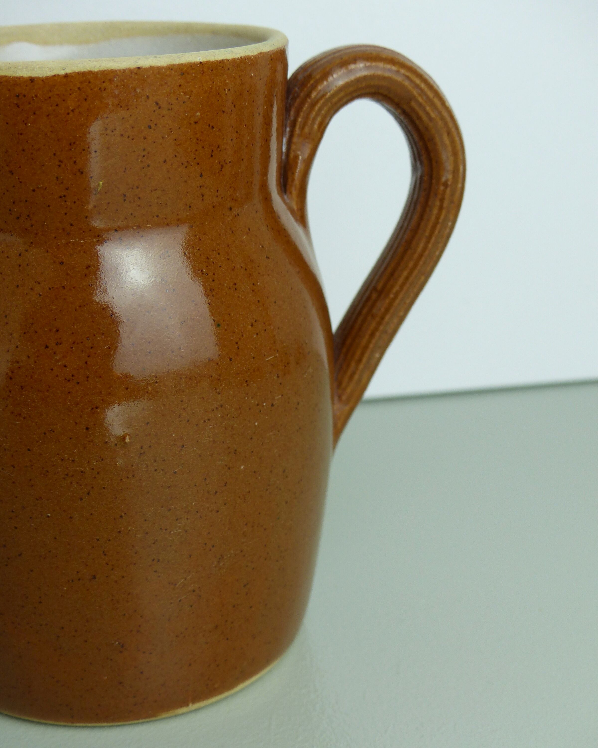 Pitcher or milk pot in speckled enamelled sandstone