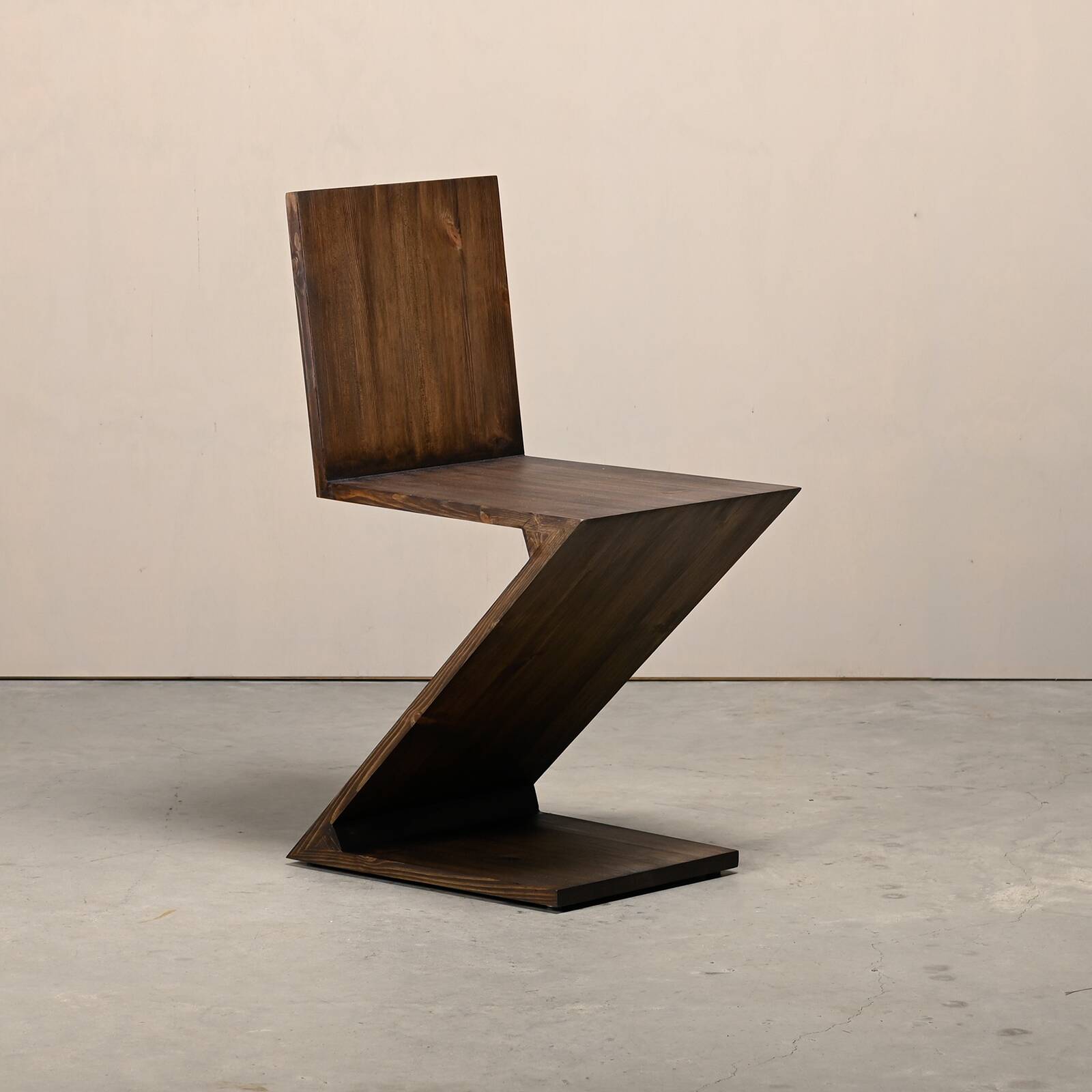 Gerrit Rietveld Zig Zag Chair is dark brown stained wood