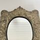 Baroque mirror in repoussé brass