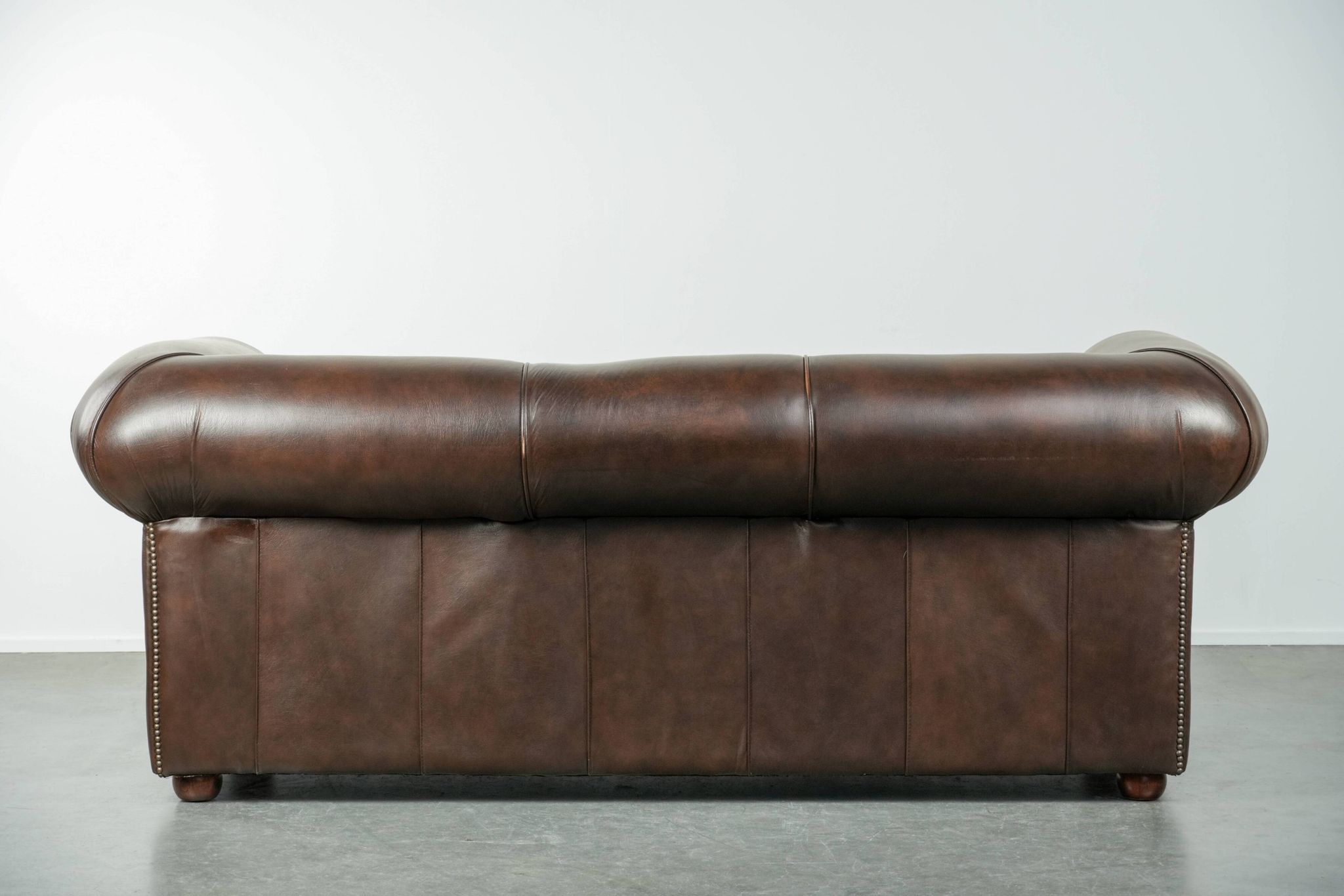 Set of a smooth chesterfield sofa and armchair with a timeless English look