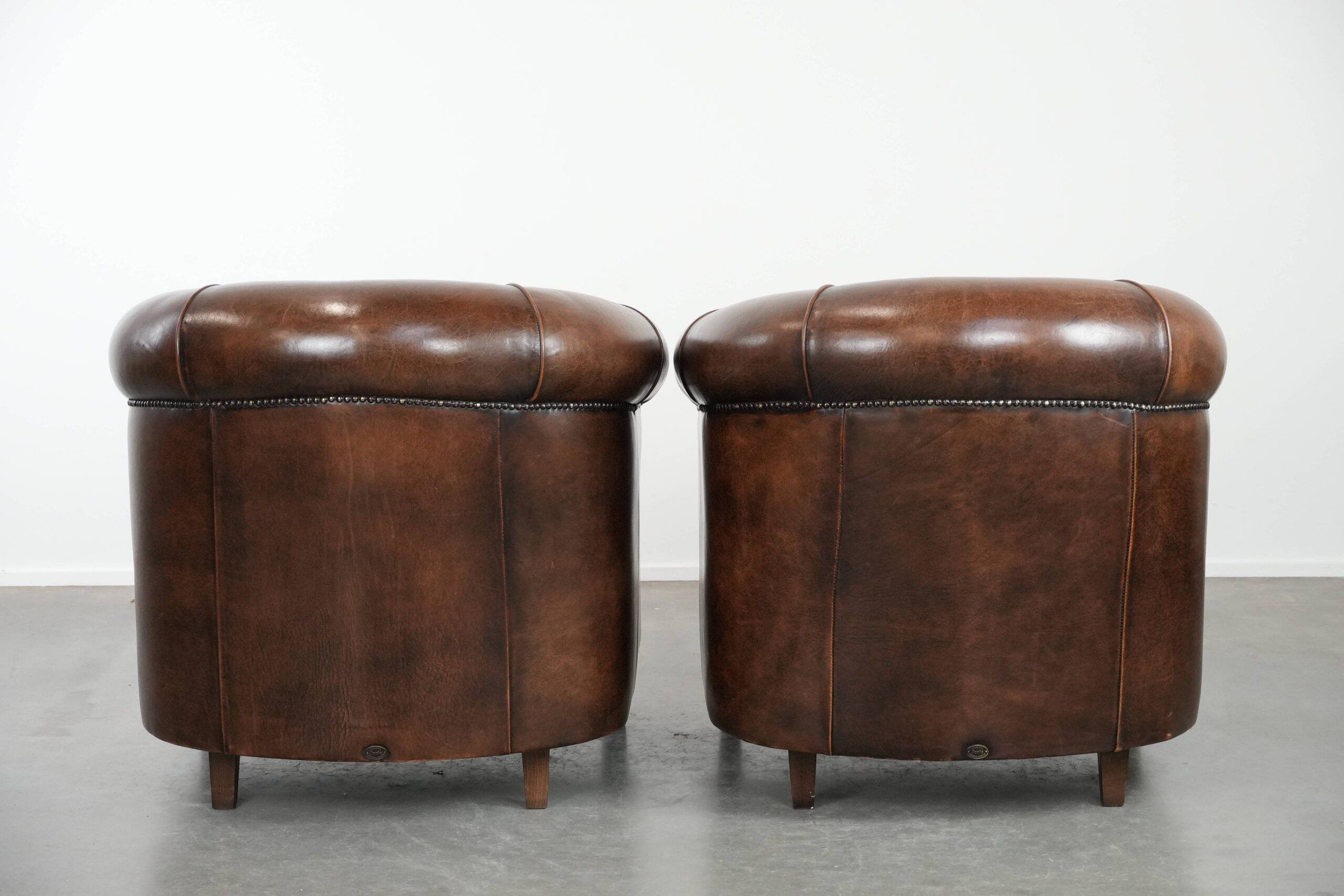Set of two sheepskin club armchairs with fixed seat cushions