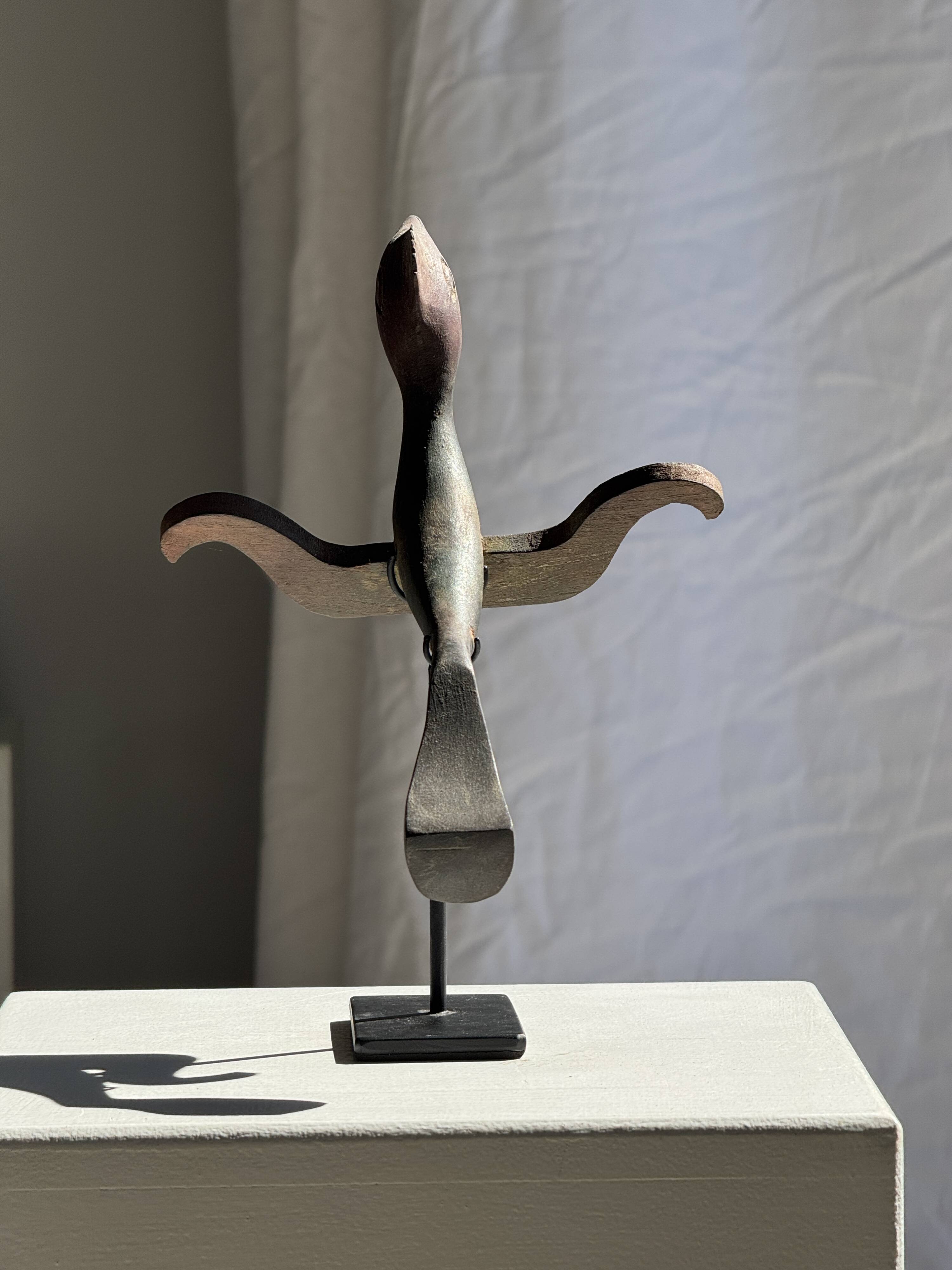 Traditional Indonesian decorative wooden bird on a base, crest model.