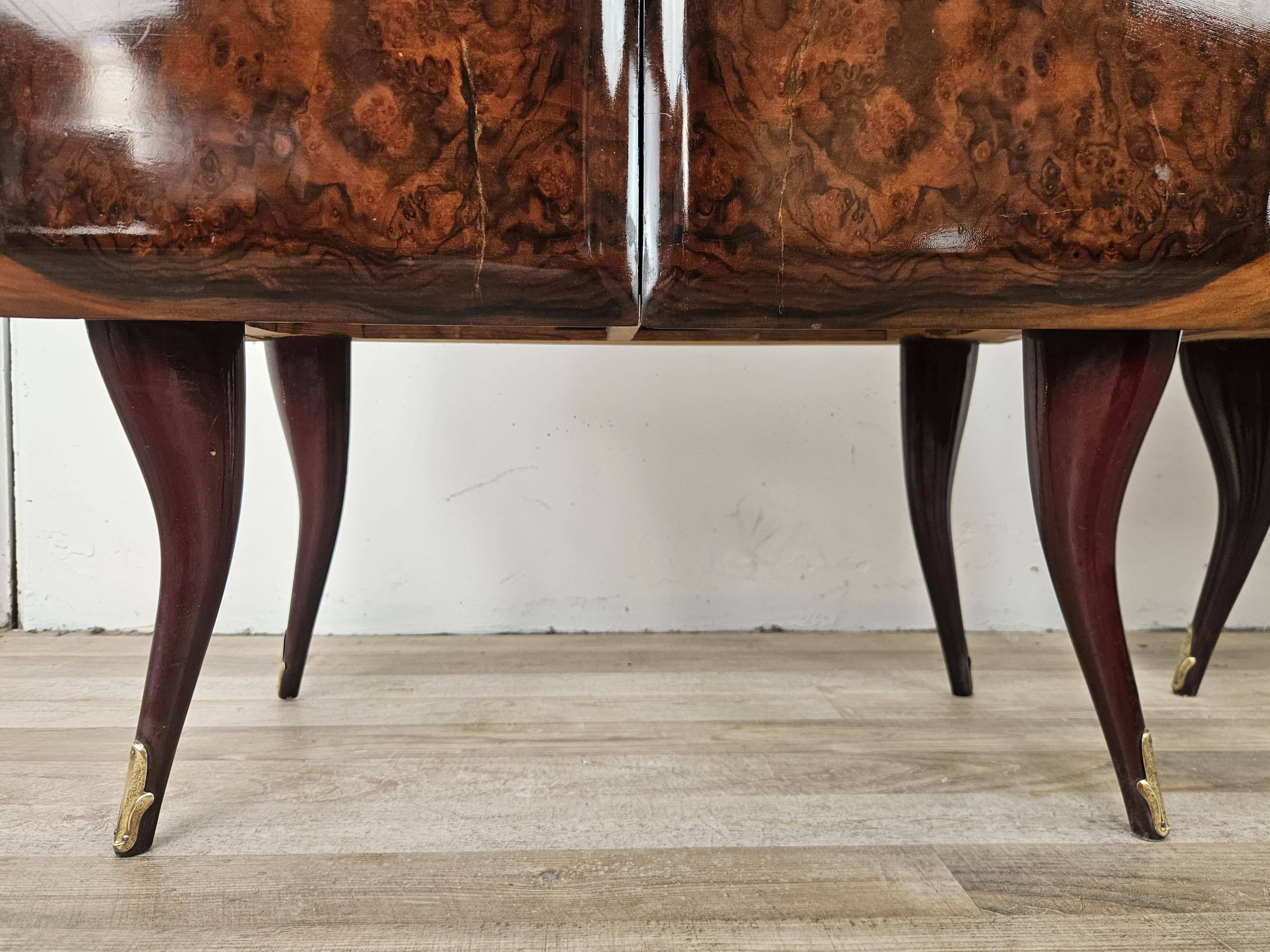 Mid-century mahogany bedside tables with mirrored tops.