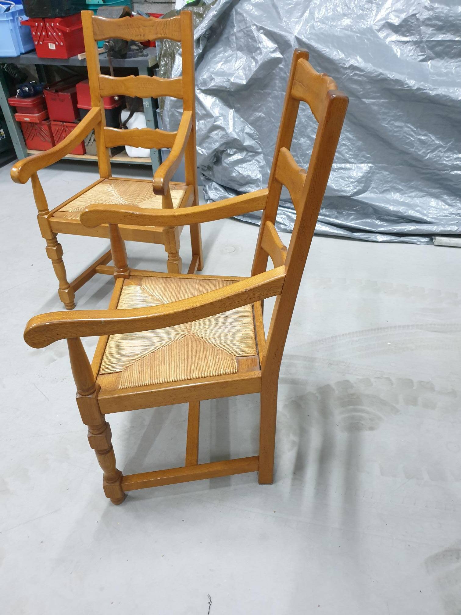 Two oak armchairs with straw seats