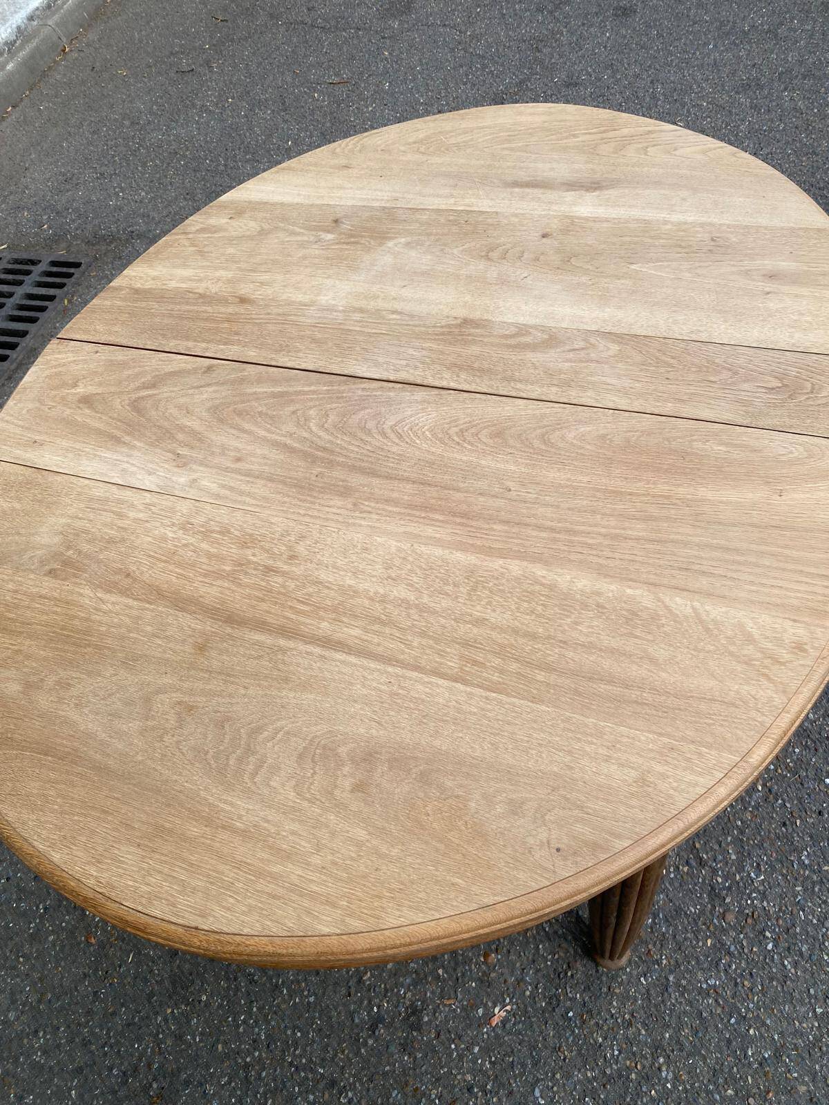 Large stripped solid oak dining table in Louis XVI style with 3 extensions.