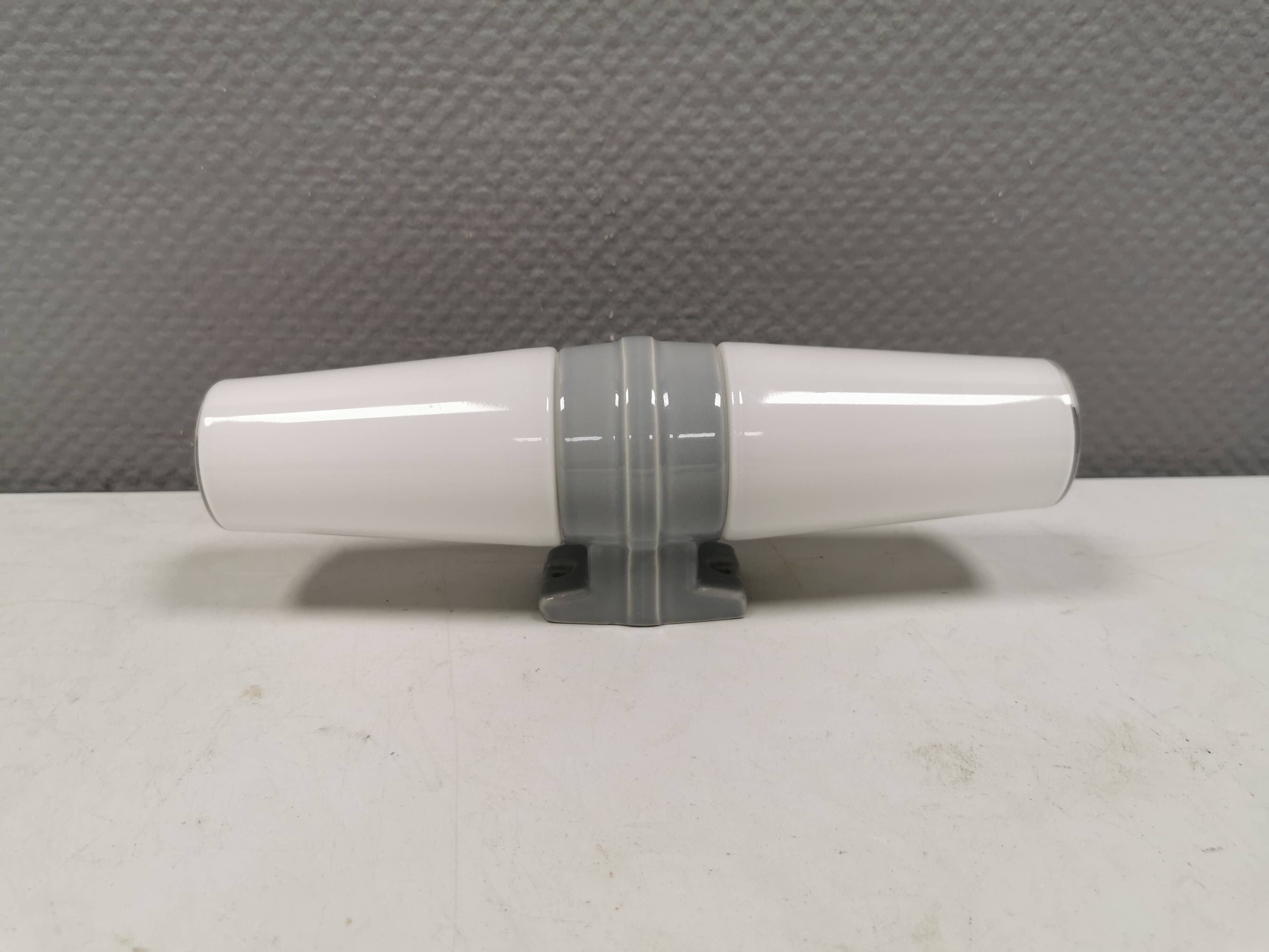 Bathroom lamp with light gray ceramic base,  and milky white opal glass.