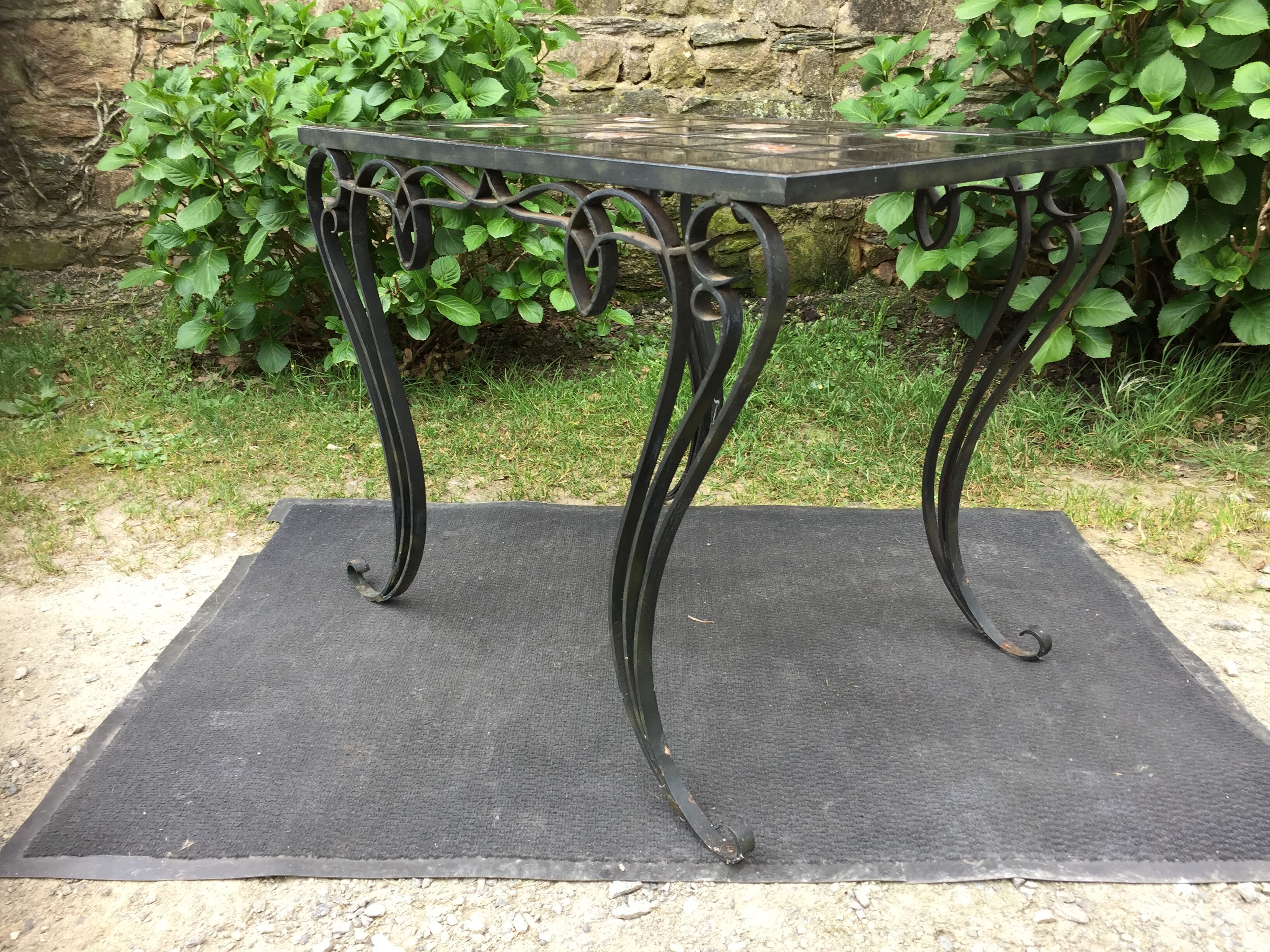 Vintage ceramic coffee table by Guy Trévoux with wrought iron base.