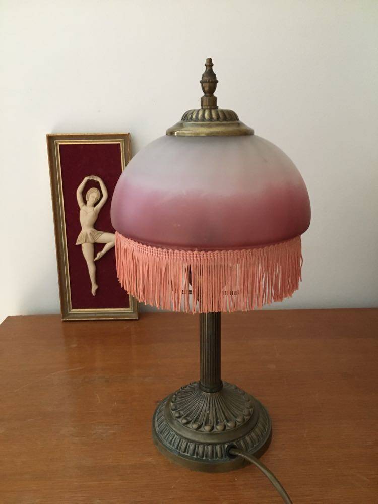 Old table/bedside lamp with glass shade with pink gradients and fringes.
