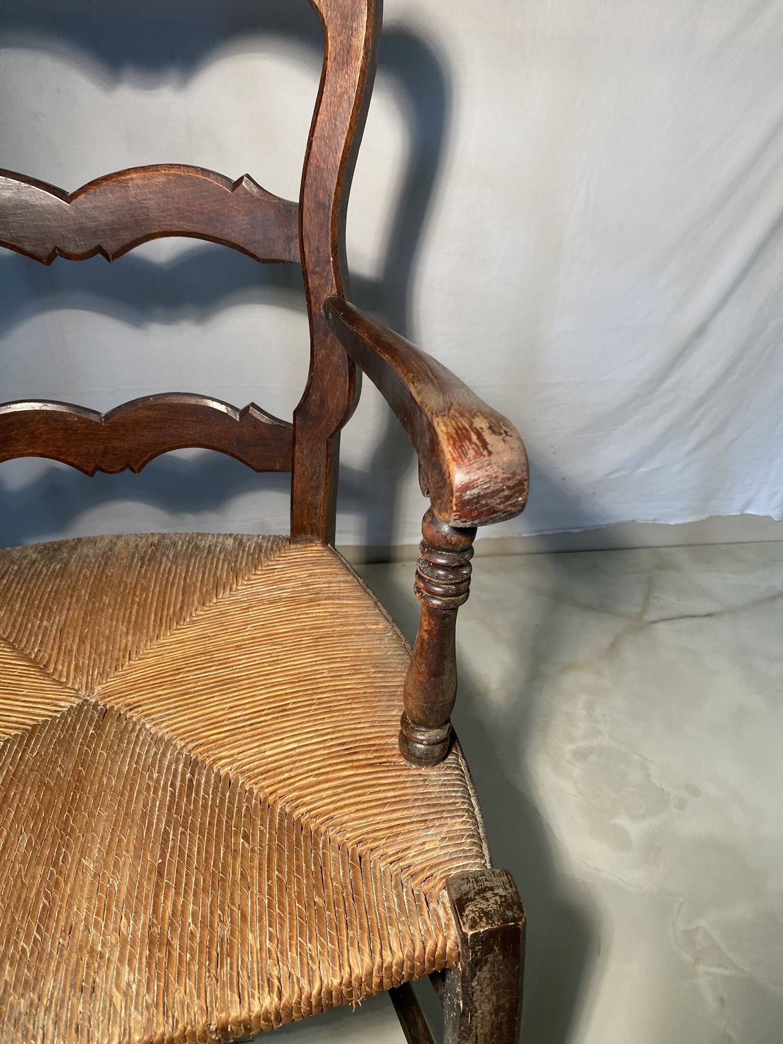 Antique Provencal armchair in carved wood with straw seat