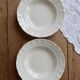 Pair of antique ivory faience deep plates ADP Luxcerae