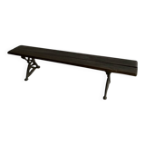 Dark brown wood and black cast-iron antique garden bench with weathered solid-wood seat