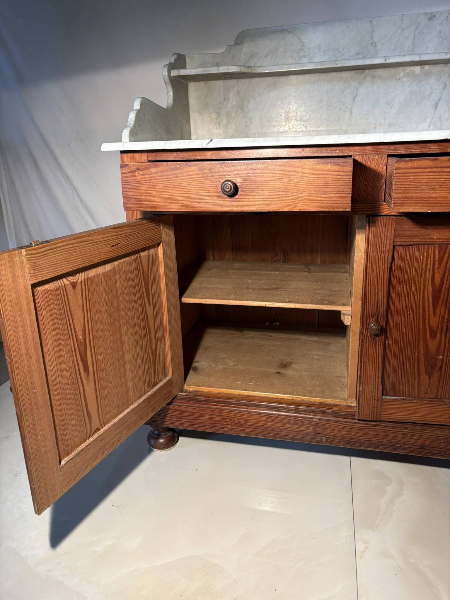 Antique wood and marble kitchen sideboard with carved backsplash