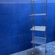Chrome and glass shelving unit on wheels from the 90s.