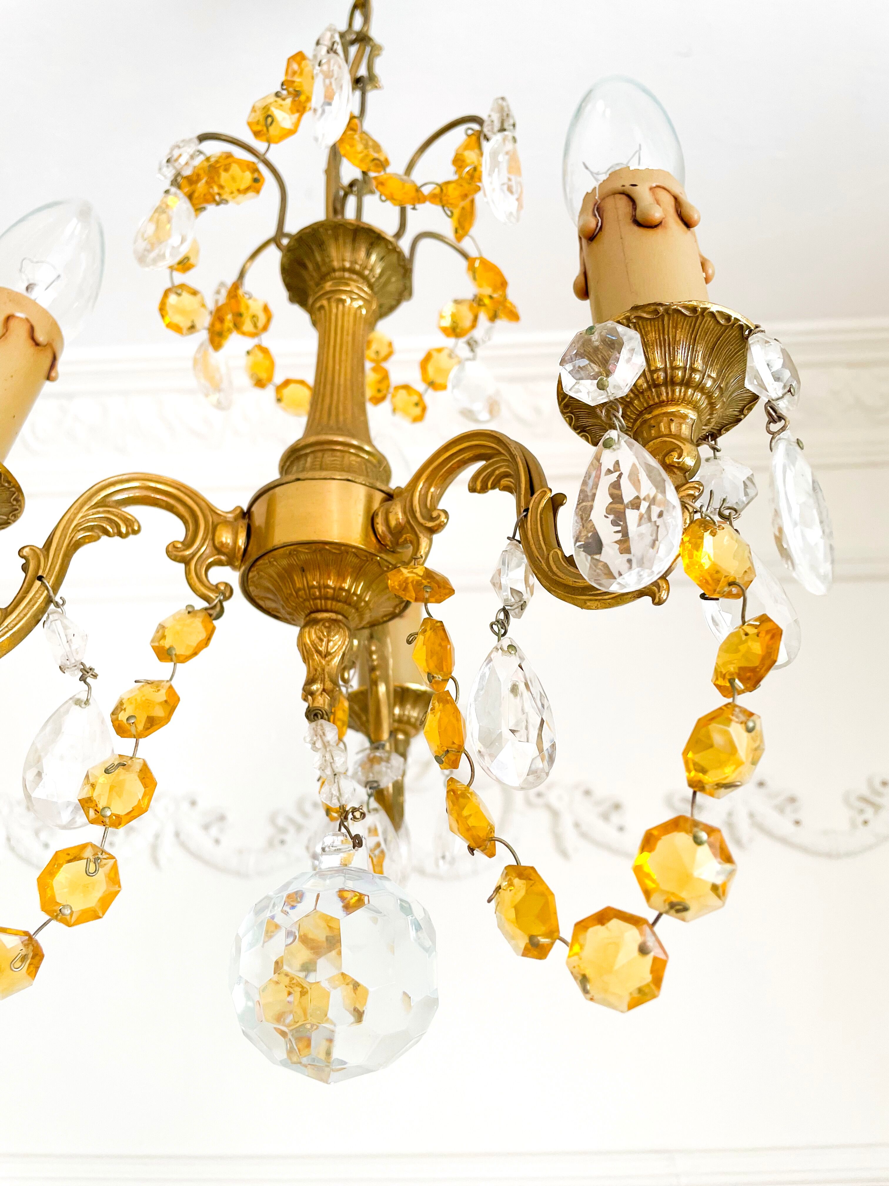 Small vintage brass chandelier with amber crystal pendants.