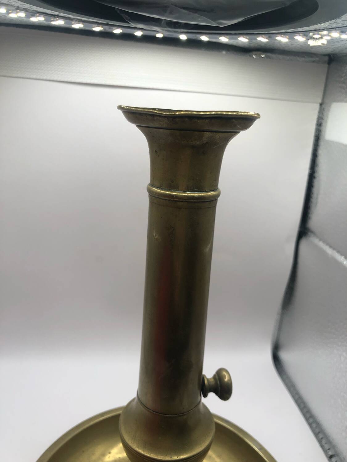 Candle holder with a pusher