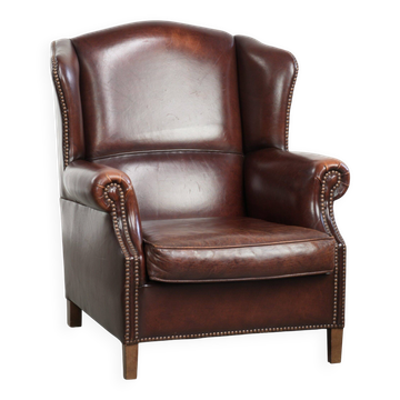 Vintage sheepskin wingback armchair with a timeless English look