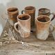 Set of 5 vintage handcrafted stoneware mugs in beige, pink, and white glazed stoneware