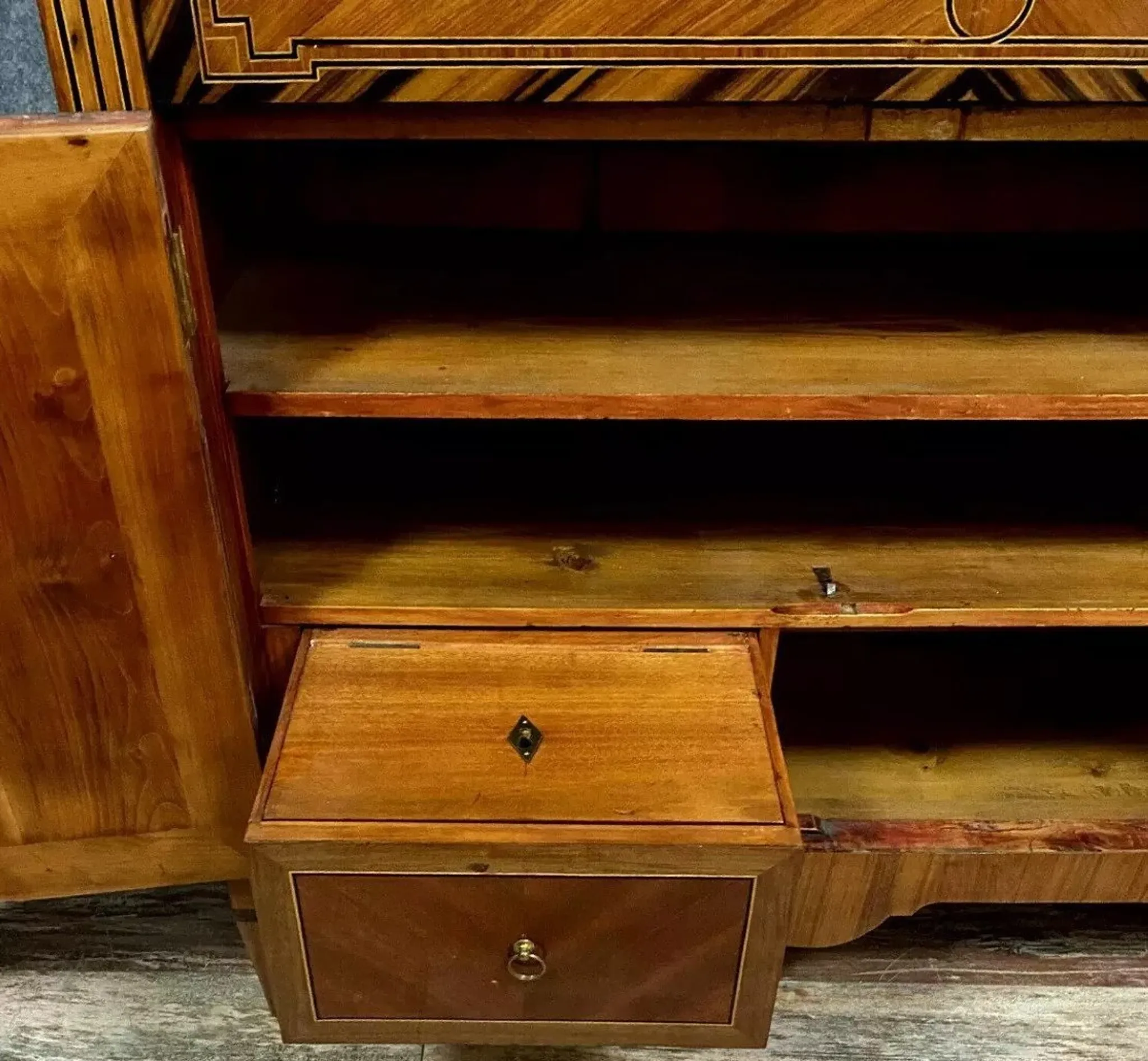 Secretary from the Louis XVI era in precious wood marquetry.