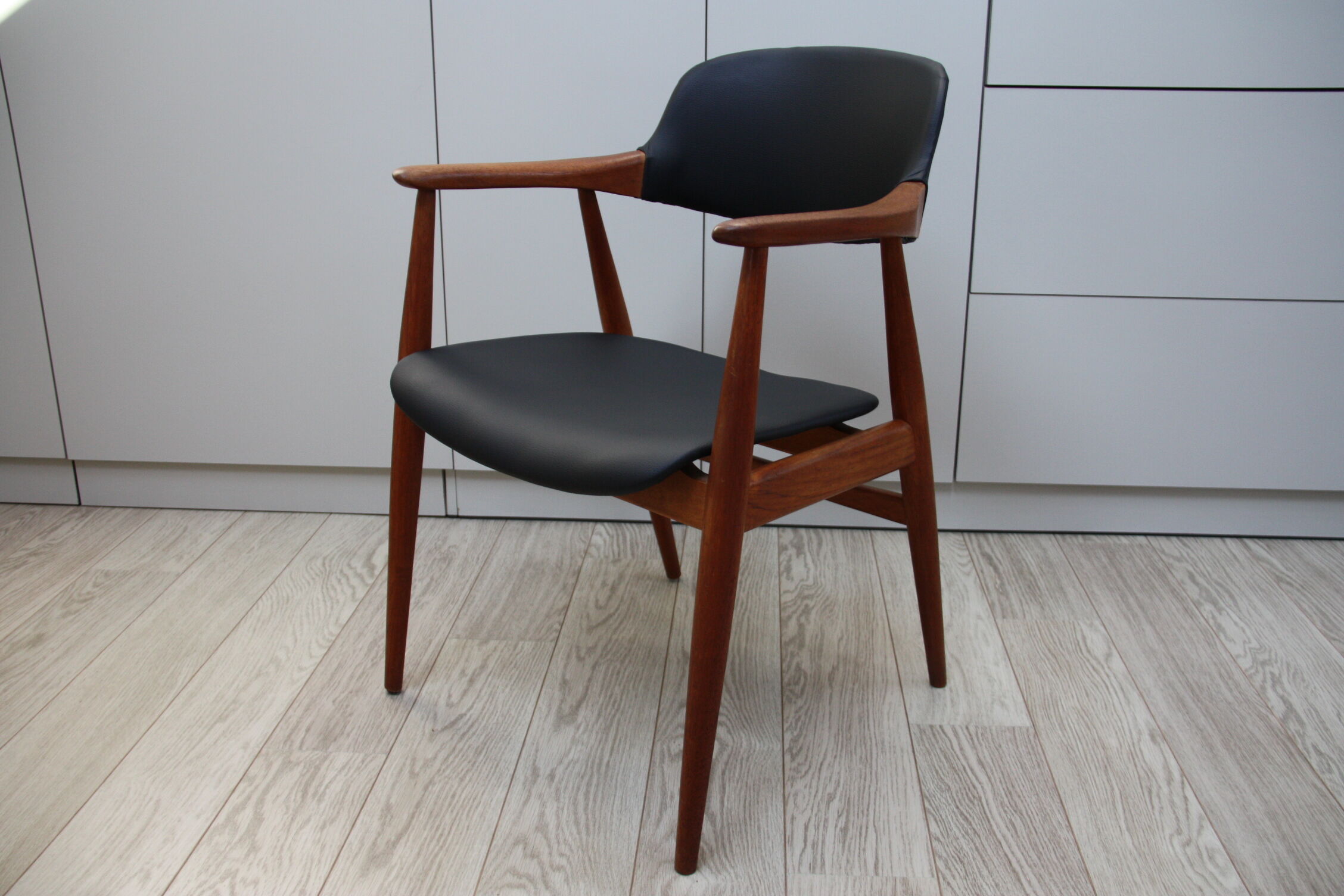 Vintage armchair in teak and black leather model Casina 60s