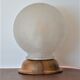 White glass globe table lamp with geometric reliefs