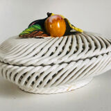 Covered basket in woven ceramic and fruit slip.