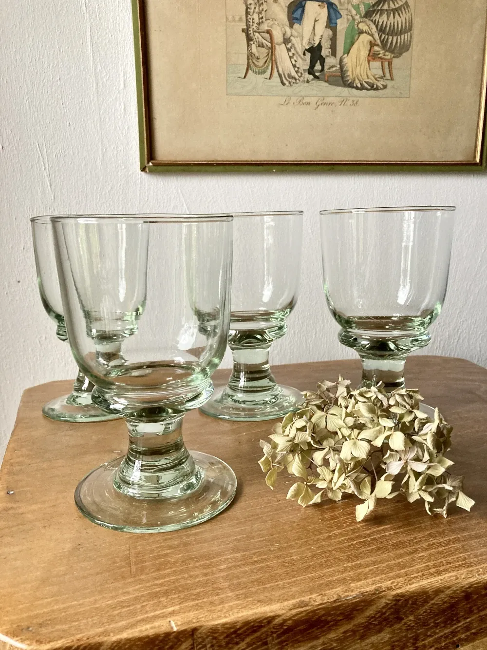 4 stemmed glasses made of handcrafted blown glass in green hue.