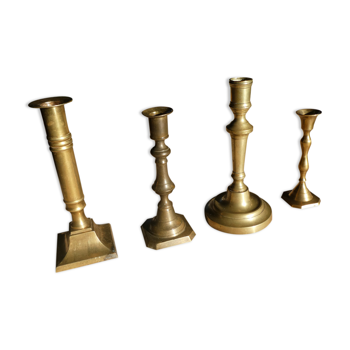 Set of 4 old candle holders in golden brass
