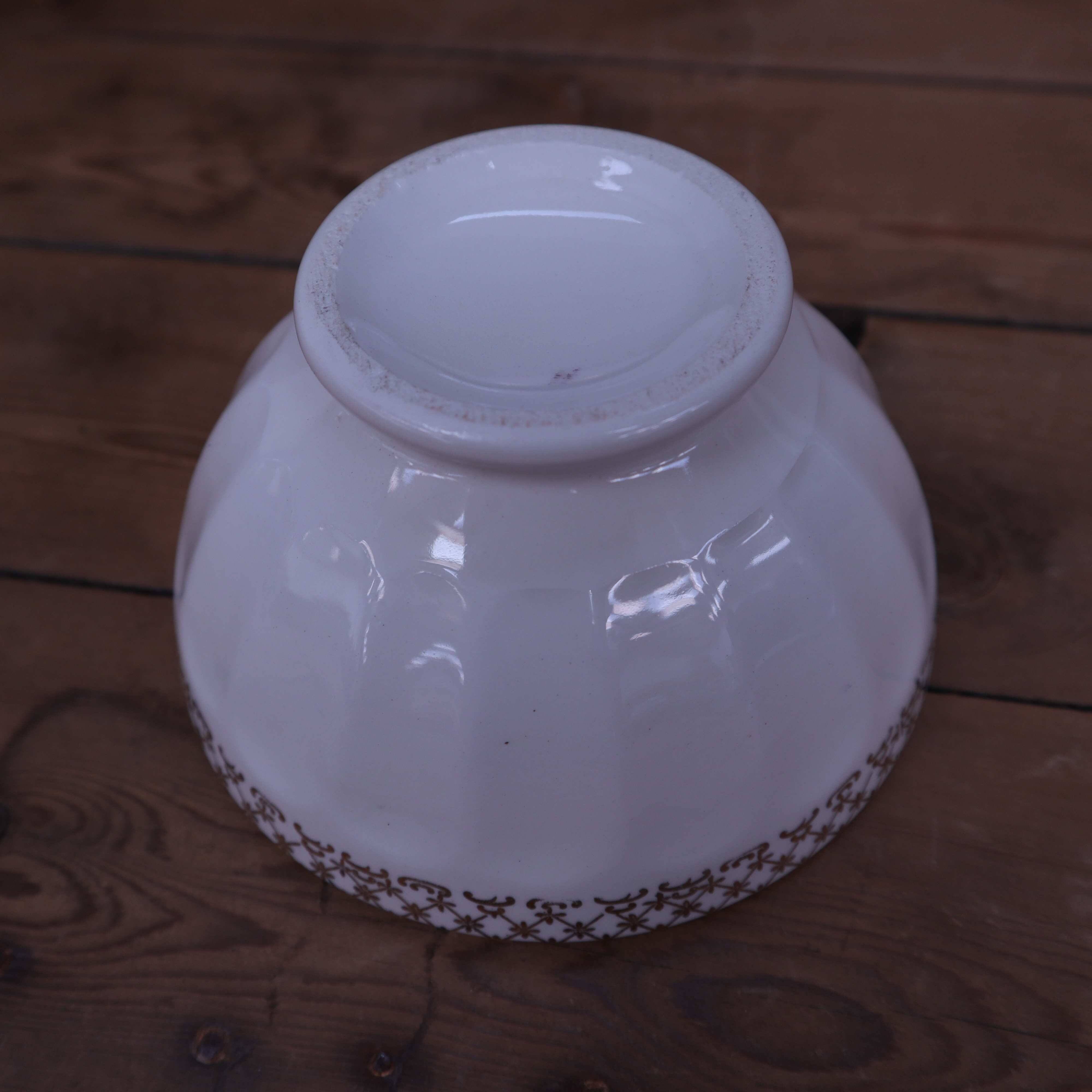 Antique white ribbed porcelain bowl with gold frieze
